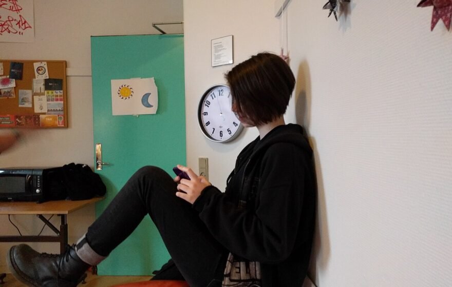 A teenager using a mobile phone