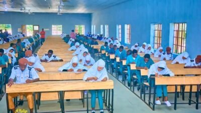 Students writing papers in an examination hall