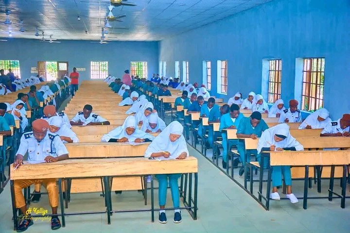 Students writing papers in an examination hall